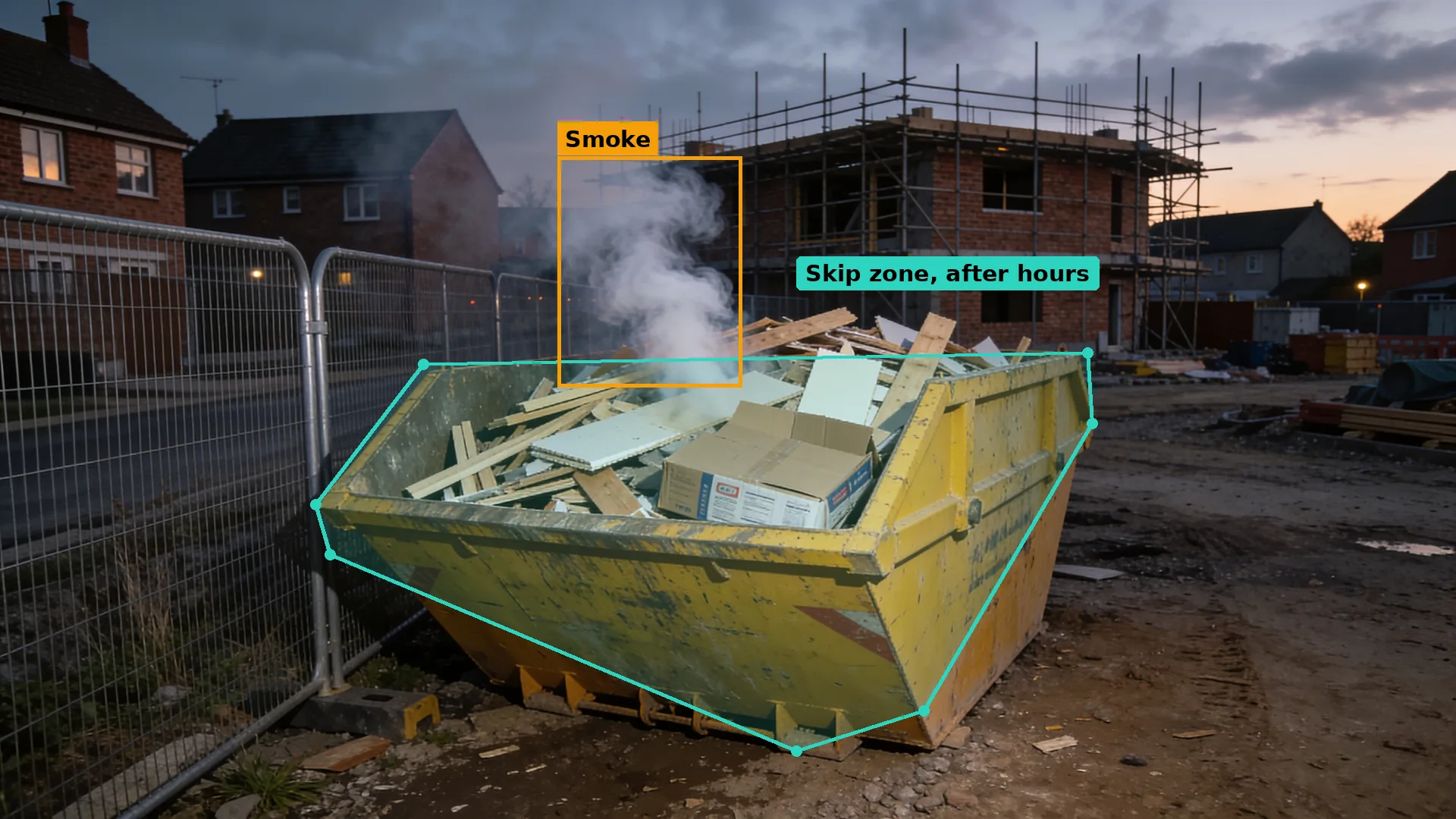 Dusk CCTV of a housing site, white smoke rising from a skip of timber offcuts by the fence, smoke boxed in amber