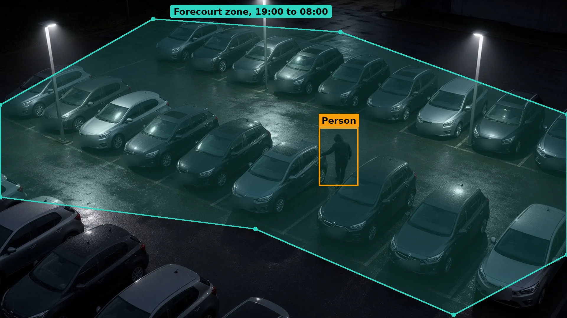 Night CCTV of a dealership forecourt, a hooded figure at a car door between the rows, in a teal zone, boxed in amber