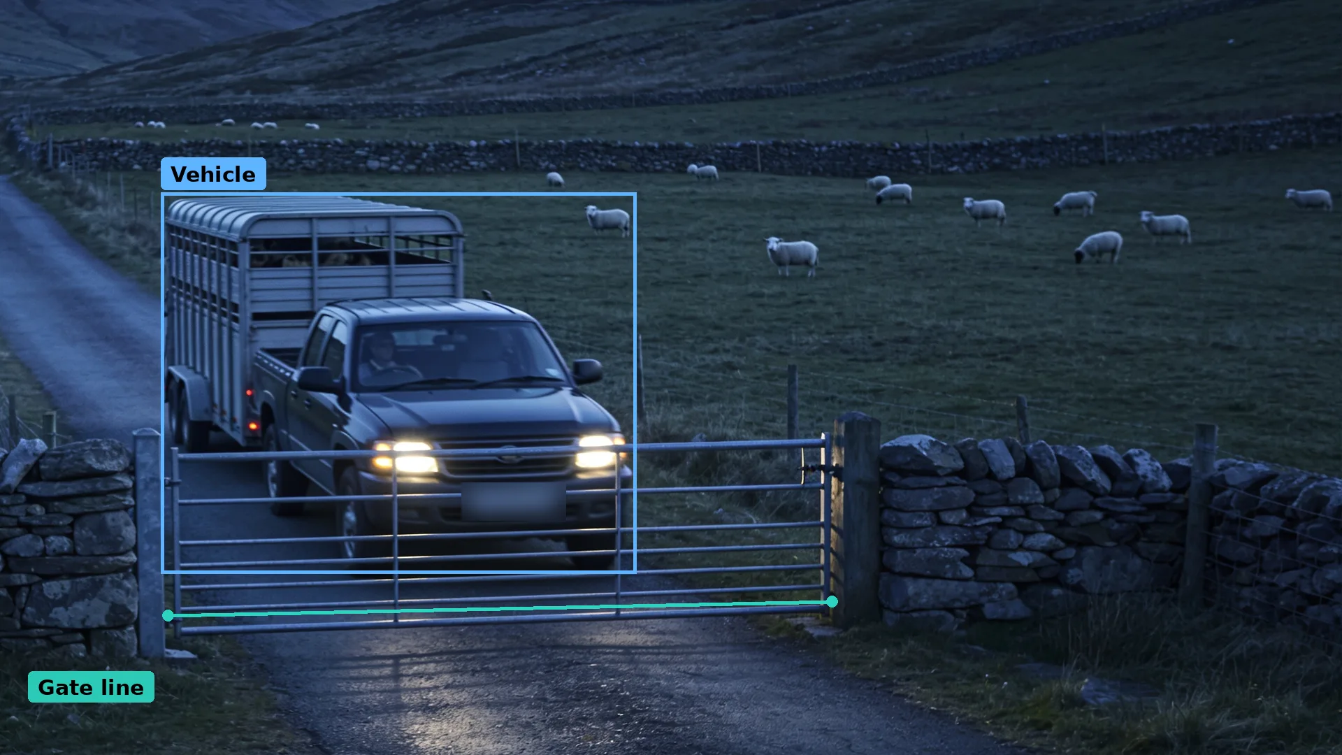 Dusk CCTV of a hill farm gate: a teal line along the gate and a pickup with a livestock trailer boxed in blue