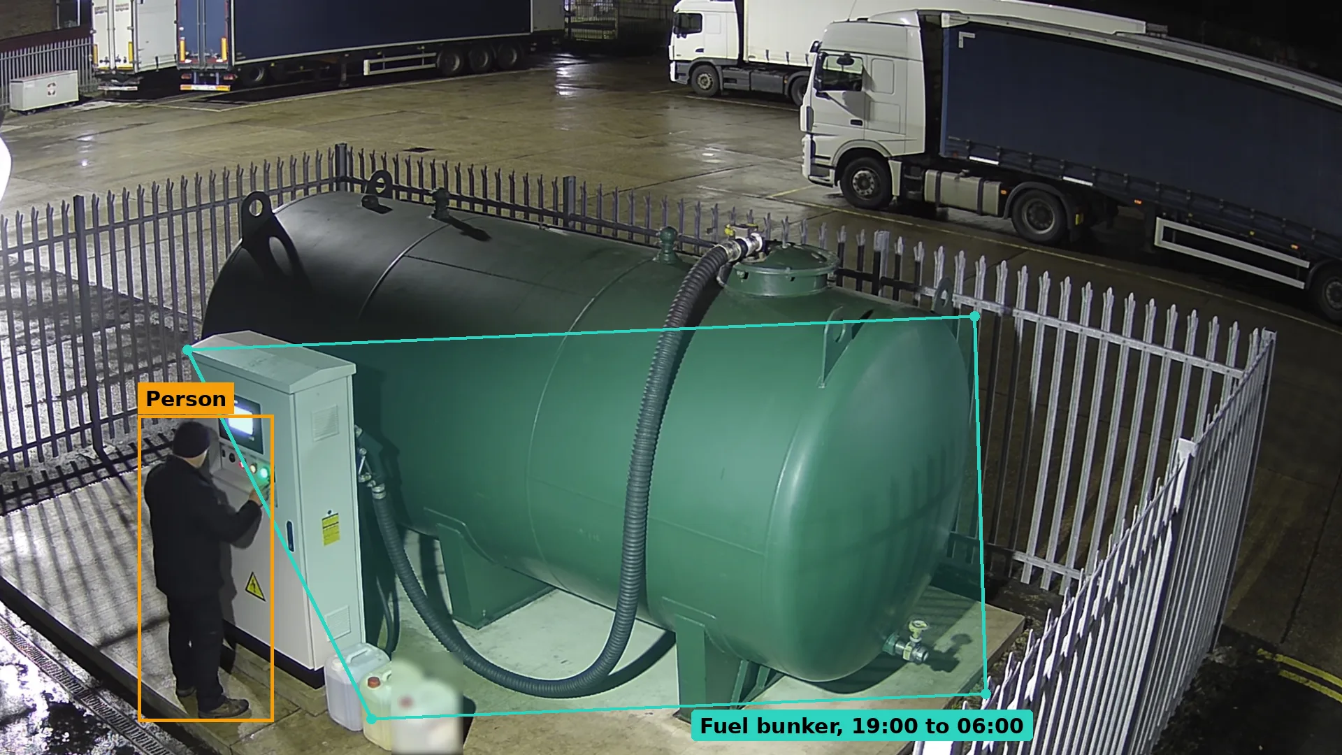 Night CCTV of a person at the pump cabinet of a green fuel bunker with jerry cans at their feet, boxed in amber
