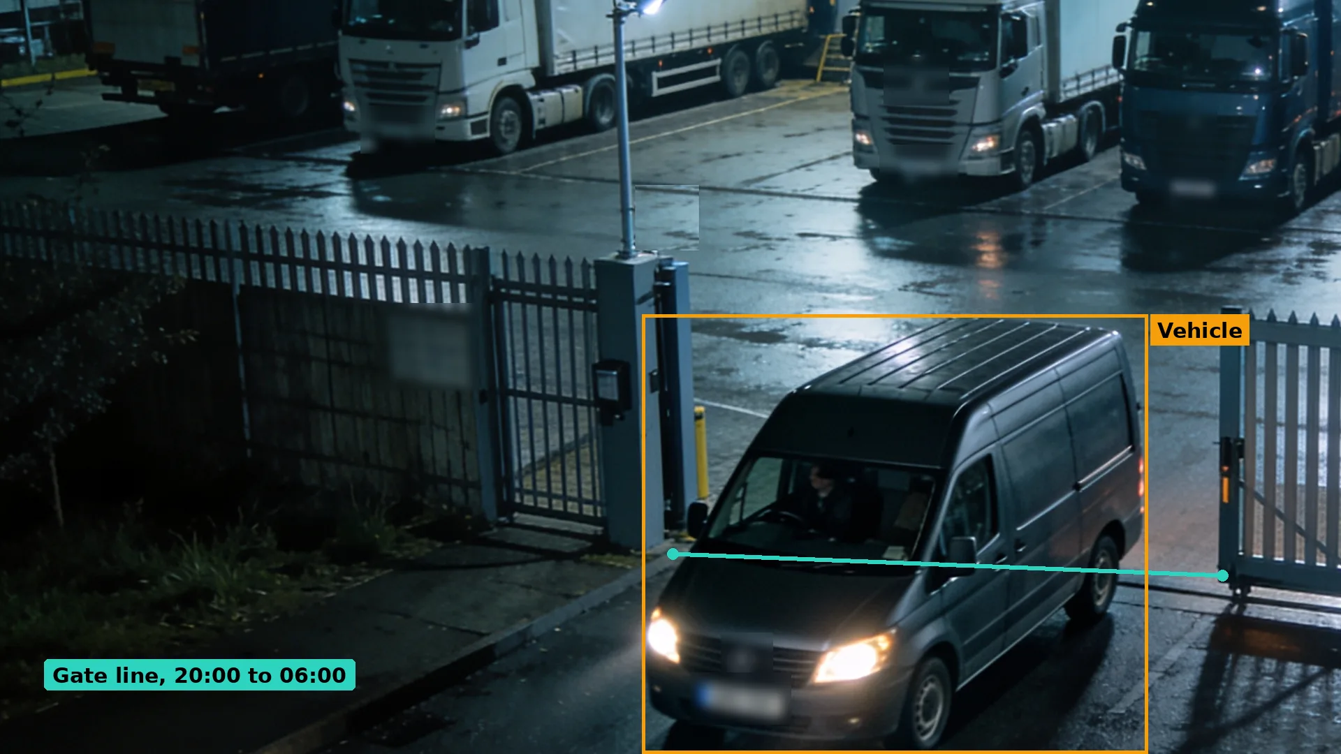 Night CCTV of a dark van driving through an open depot gateway past parked tractor units, boxed in amber