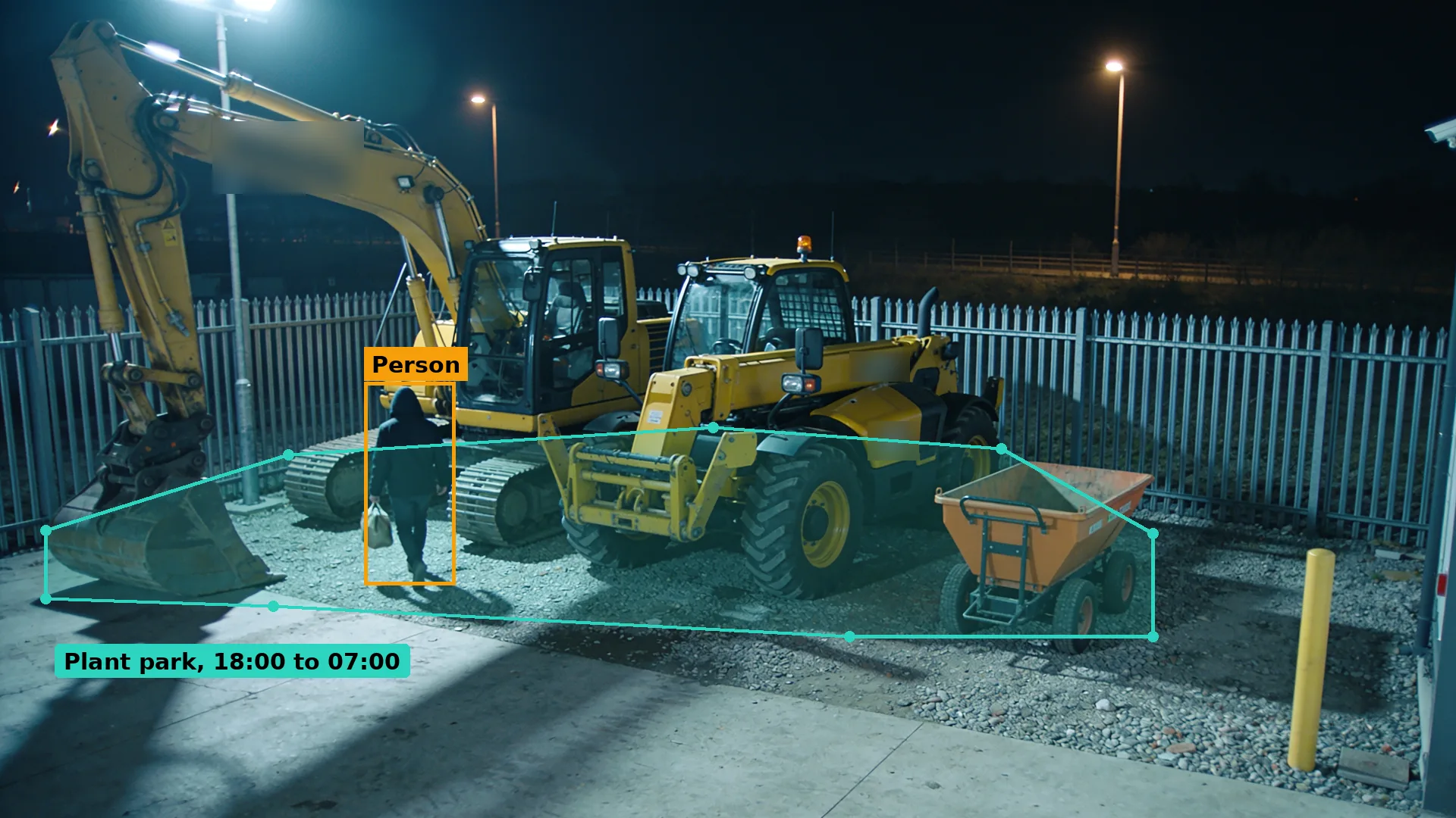 Night CCTV of a plant yard, a person in dark clothing walking towards a parked excavator and telehandler, boxed in amber