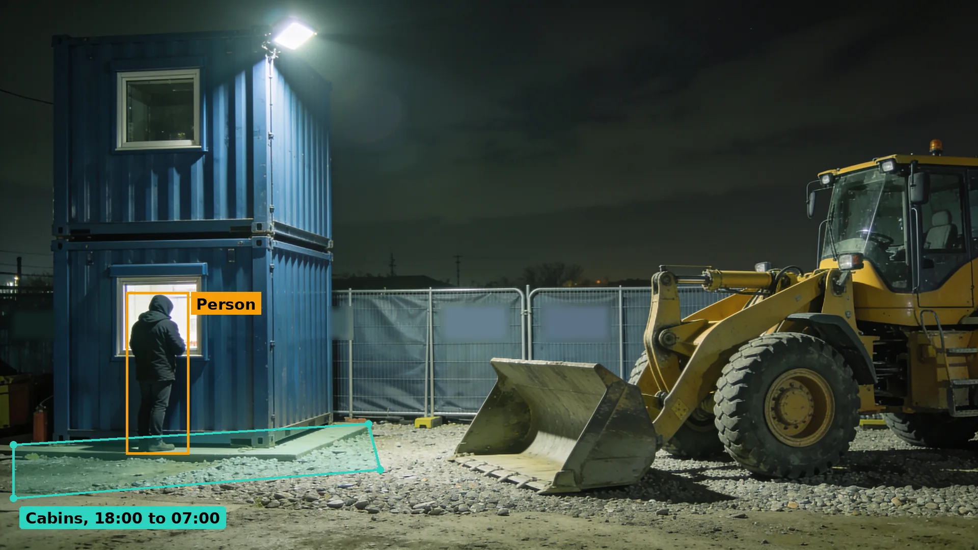 Night CCTV of a hooded person at the window of a stacked site cabin next to a parked wheel loader, boxed in amber