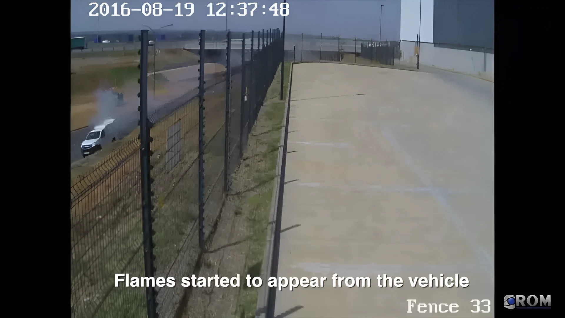 Real CCTV frame of a vehicle fire with smoke and flame boxed by Woodcock AI