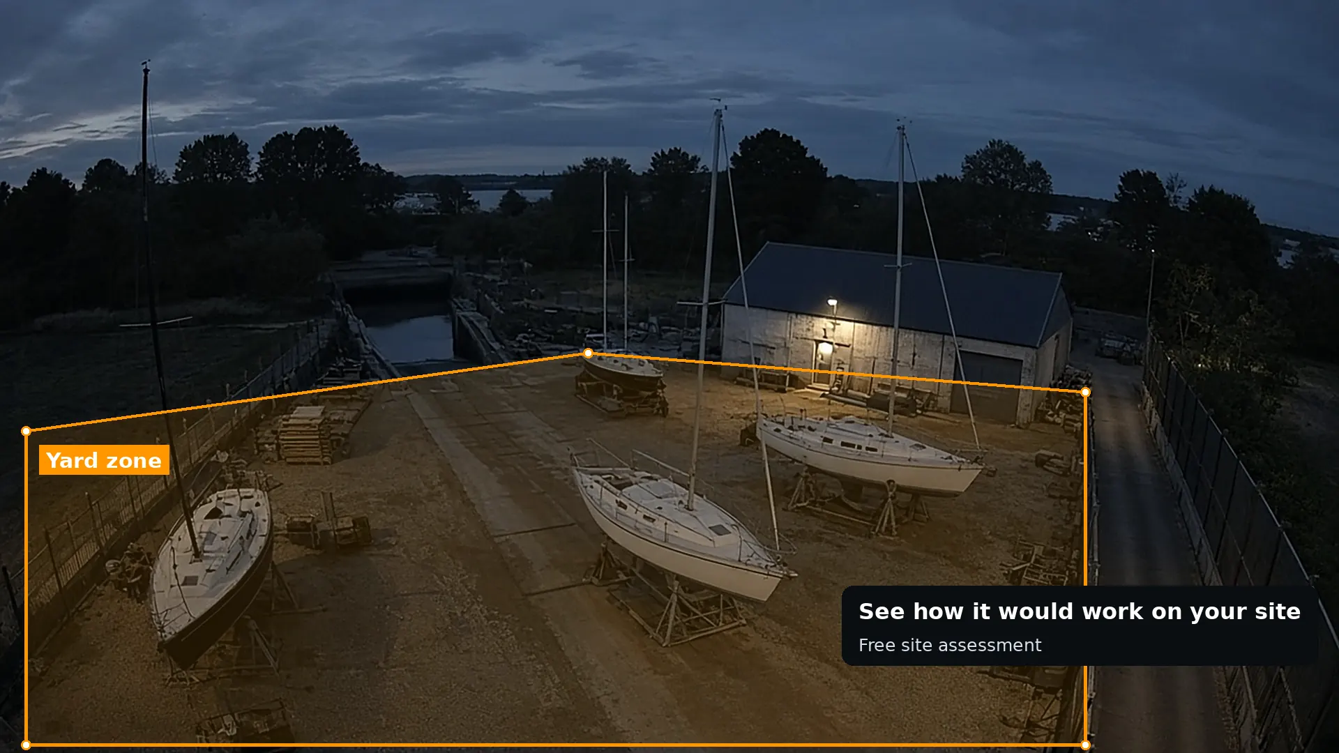 Dusk CCTV of a boatyard with boats on cradles inside a drawn yard zone