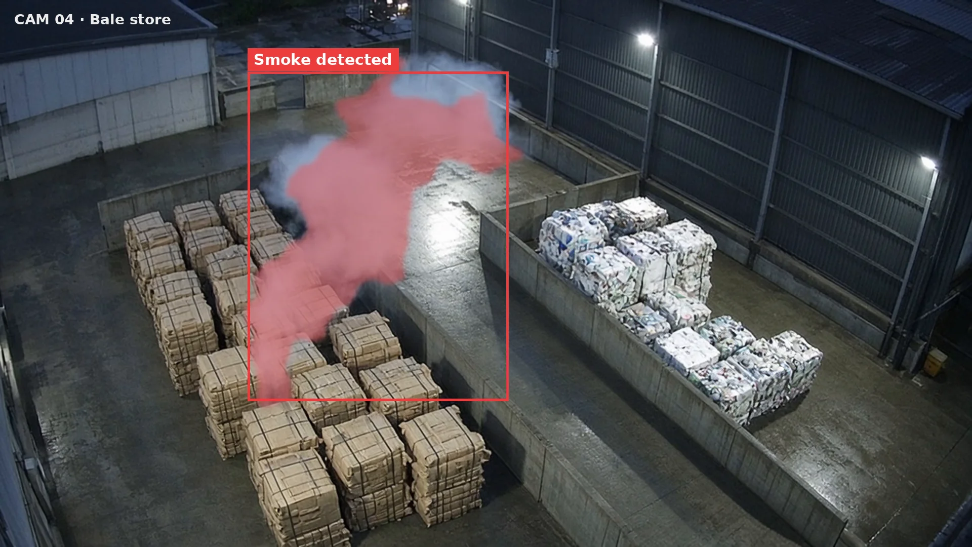 High CCTV view of a bale store where smoke rises from one bale and is boxed as smoke detected