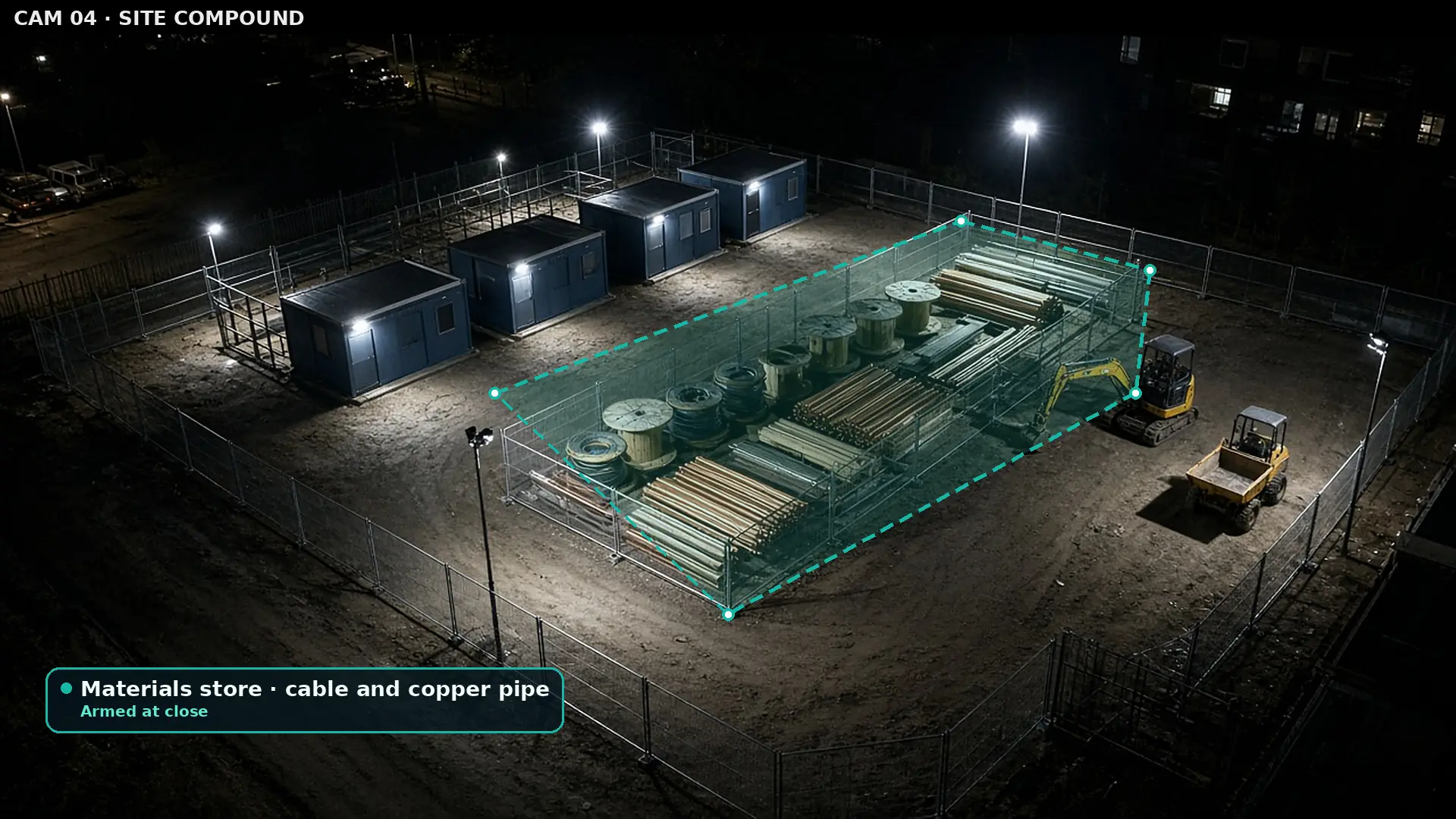 Night camera view of a construction compound with a materials container, stacked pipe and cable drums, outlined by a teal polygon zone labelled armed, and no people present