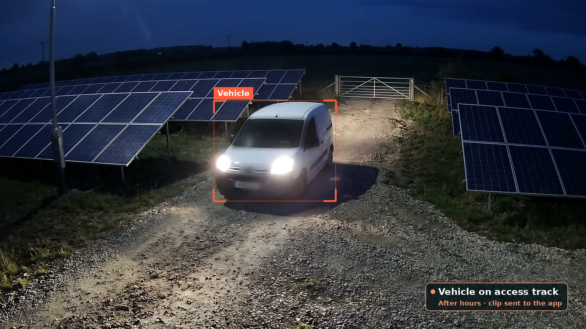 White van with its headlights on driving along a gravel access track between solar panel rows at night, boxed by a red detection box, with an alert card saying a vehicle is on the access track after hours
